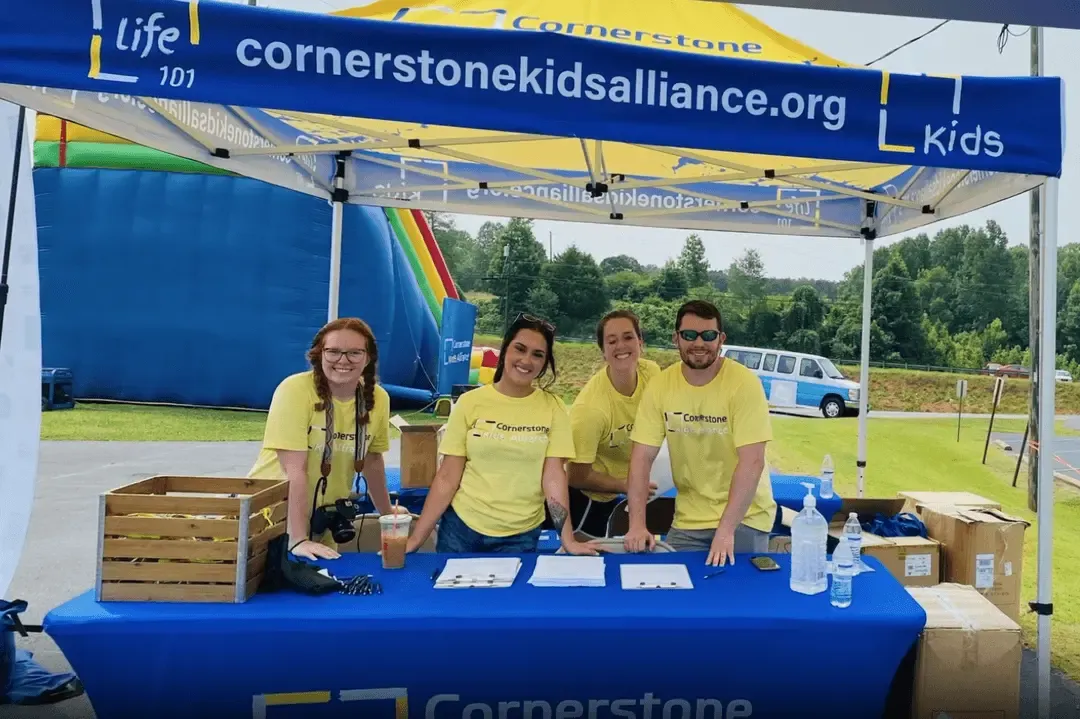 Cornerstone Construction employees table at a Cornerstone Kids Alliance community event.